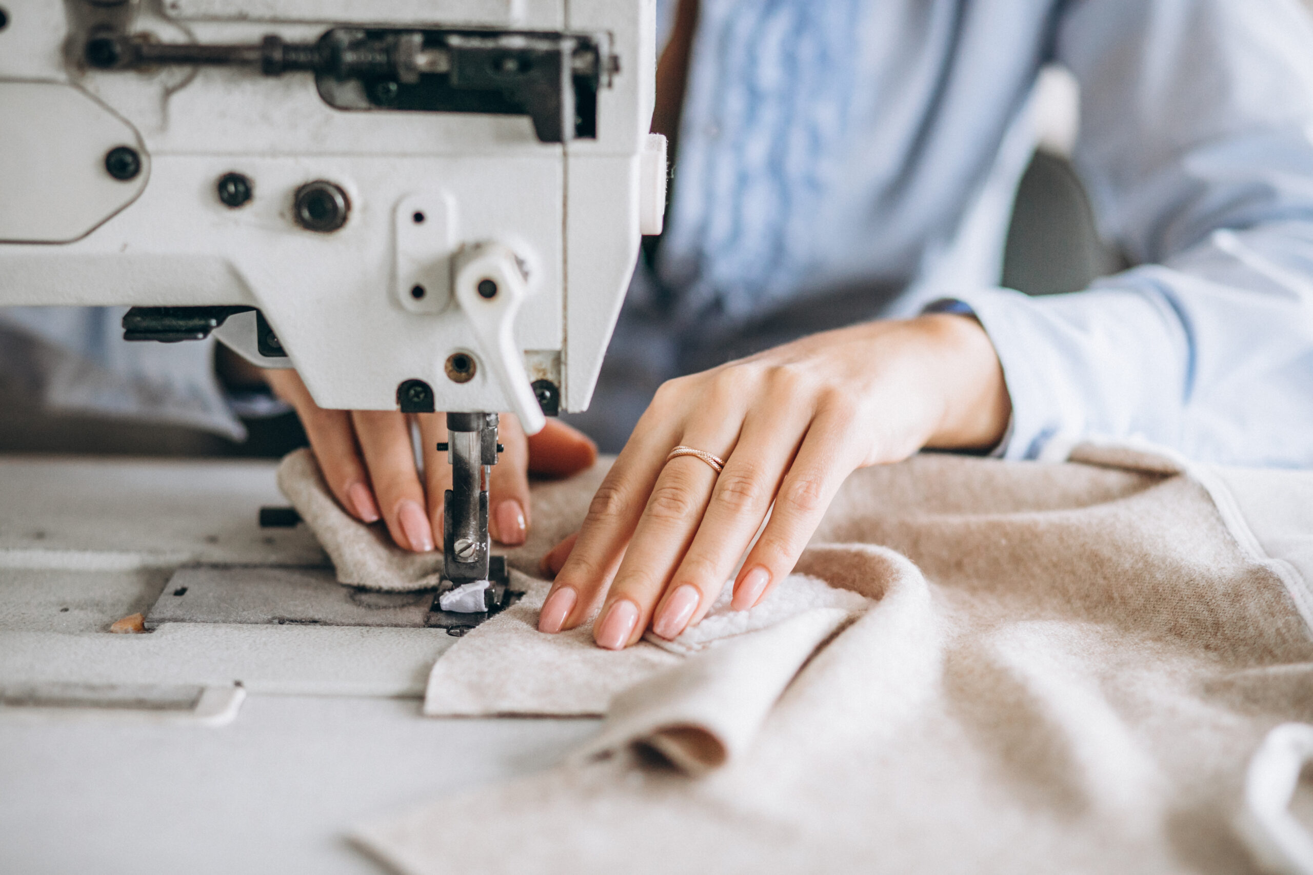 Woman tailor working at the sewing factory Woman tailor working at the sewing factory